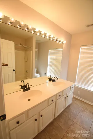 a bathroom with a double vanity sink mirror and