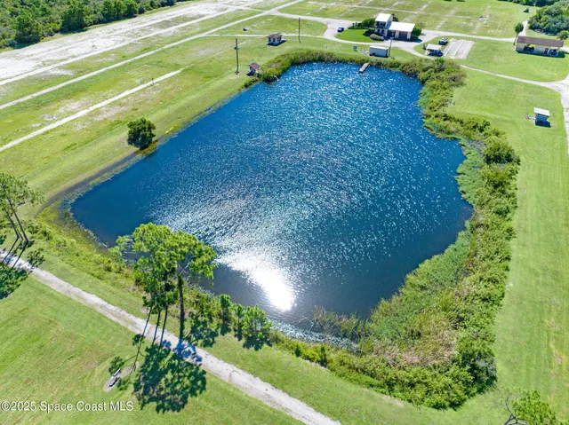 a view of a swimming pool and a yard