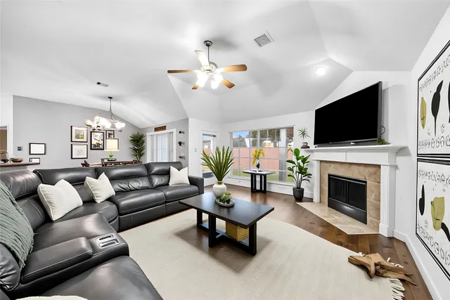 a living room with furniture a flat screen tv and a fireplace