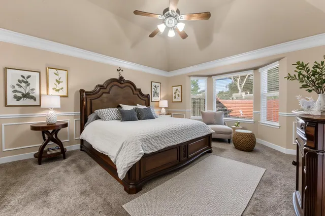 a bedroom with a bed and a chandelier
