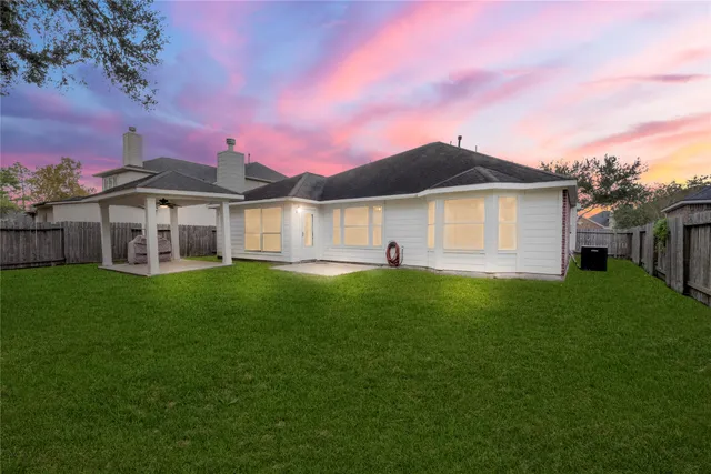 a front view of a house with a garden and yard