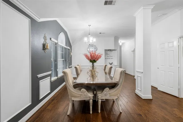 a view of a dining room with furniture and wooden floor