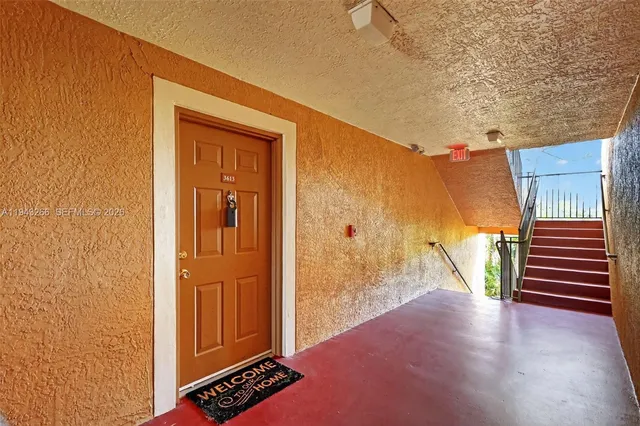 a view of a hallway with wooden walls and stairs