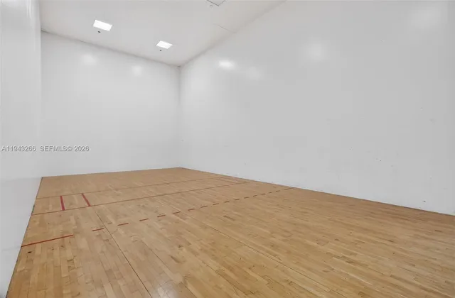a row of palm trees and swimming pool in the patio
