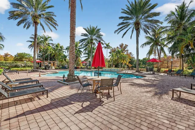 a view of swimming pool with a patio and a lake view