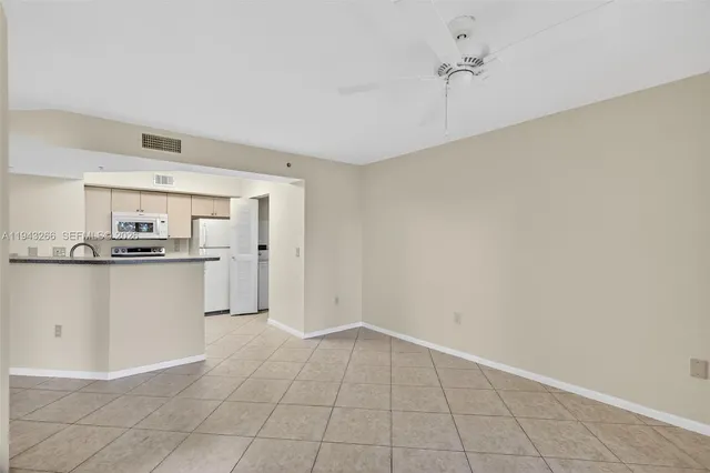 a kitchen with stainless steel appliances a sink stove refrigerator and cabinets