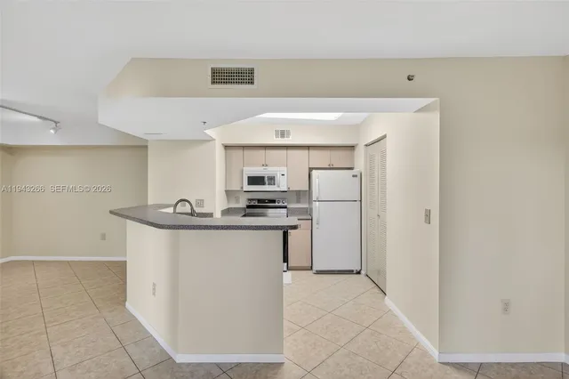 a view of kitchen with granite countertop window and a sink