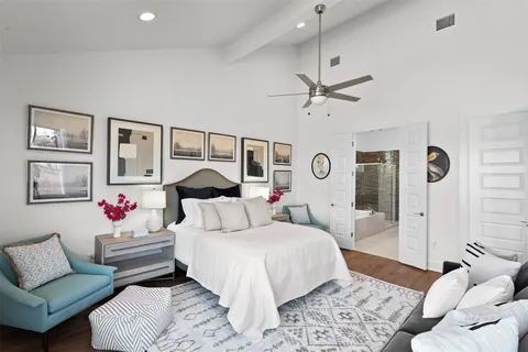 a bedroom with a bed couches and white walls