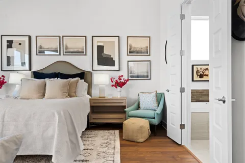 a bedroom with furniture and wooden floor