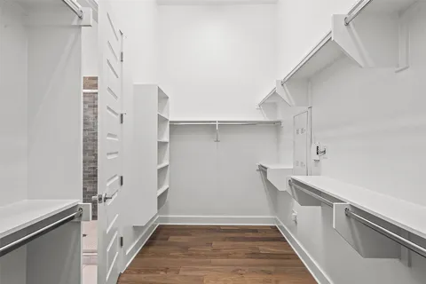 a view of walk in closet with empty racks