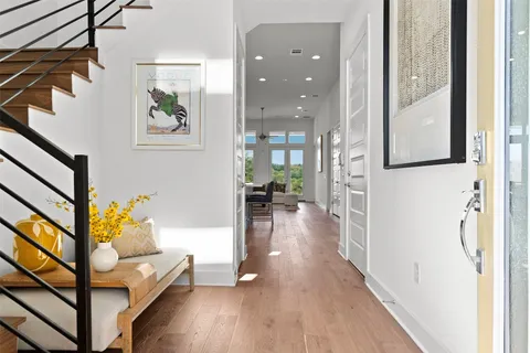 a living room with furniture and a wooden floor