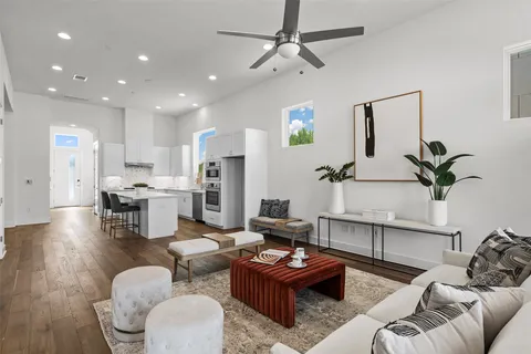 a living room with furniture and kitchen view
