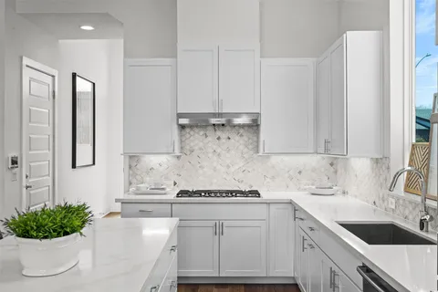 a kitchen with a white cabinets and white appliances