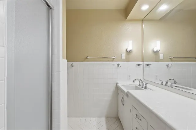 a bathroom with a double vanity sink and a mirror