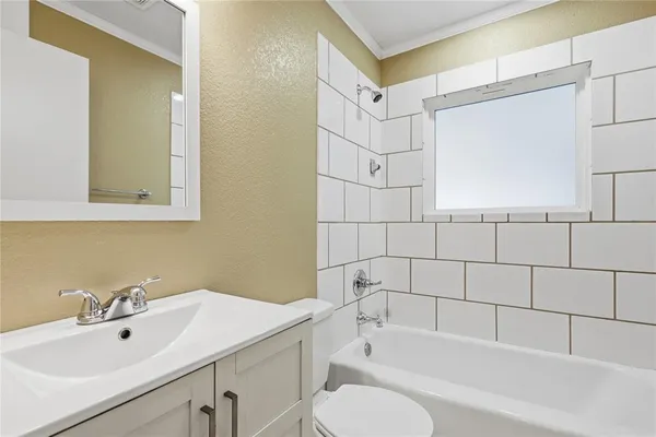 a bathroom with a sink mirror toilet and bathtub