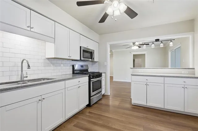 a kitchen with cabinets appliances and a sink