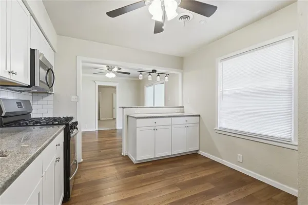 a kitchen with a stove oven and sink