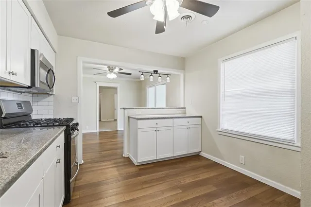 a kitchen with a stove oven and sink