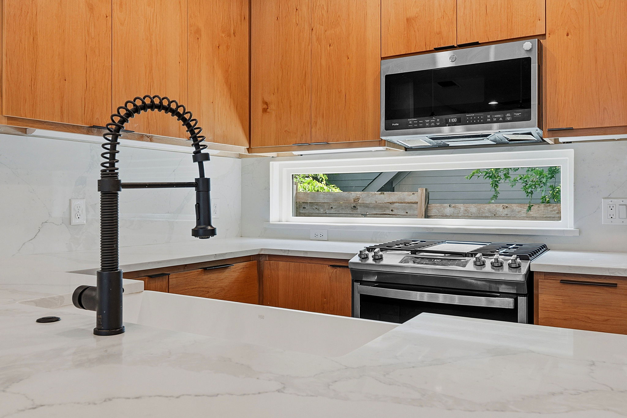 1707 Deloney Street, Unit 2 Austin, TX 78721 - Photo 10 of 26 Culinary delights await in this modern kitchen with gleaming countertops and a convenient over-the-range microwave.