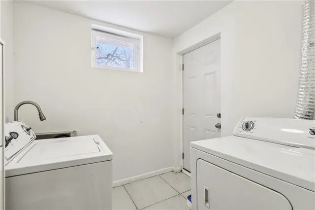 a view of backyard with tree and wooden fence