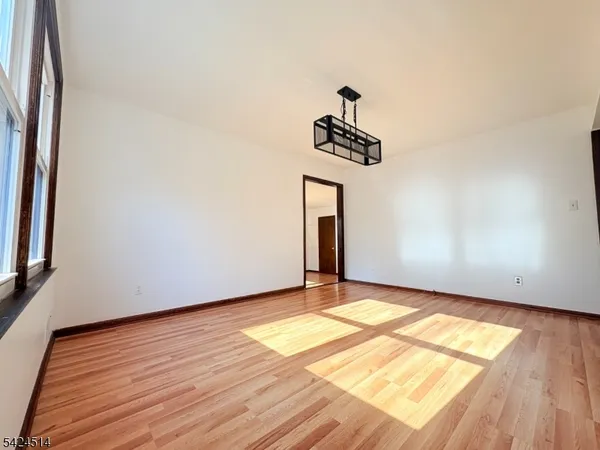 a view of wooden floor and window in a room