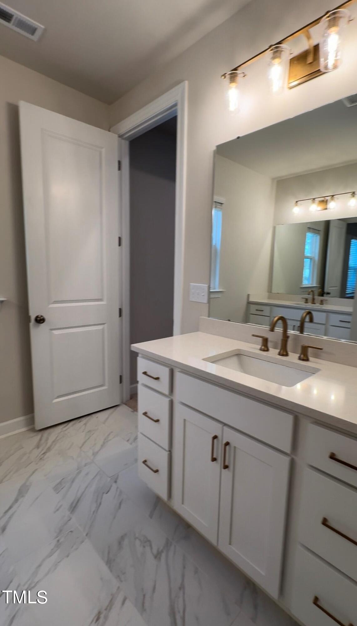 6104 Adecor Way Raleigh, NC 27617 - Photo 32 of 37 a bathroom with a double vanity sink and mirror