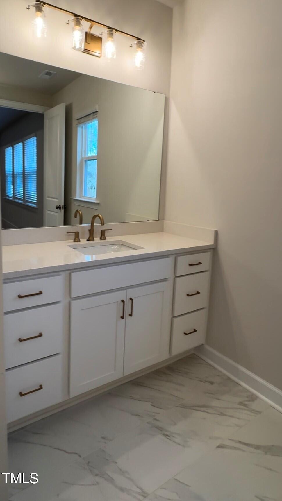 6104 Adecor Way Raleigh, NC 27617 - Photo 33 of 37 a bathroom with a double vanity sink and mirror