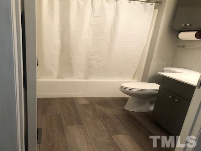 2822 Ellis Road Durham, NC 27703 - Photo 12 of 37 a bathroom with a toilet and a shower curtain
