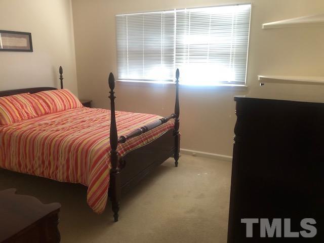 2822 Ellis Road Durham, NC 27703 - Photo 13 of 37 a bedroom with a bed and a window