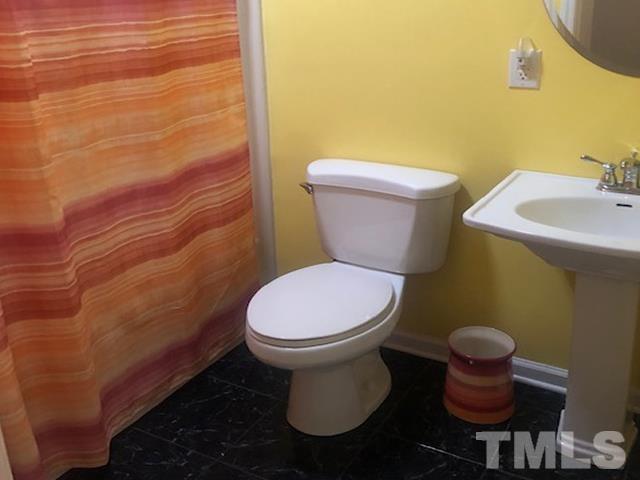2822 Ellis Road Durham, NC 27703 - Photo 15 of 37 a white toilet sitting next to a bathroom sink