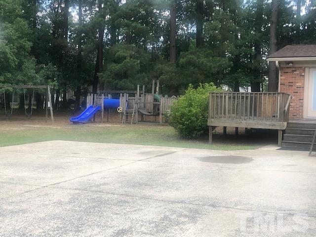 2822 Ellis Road Durham, NC 27703 - Photo 22 of 37 a view of a wooden deck with chairs and a yard