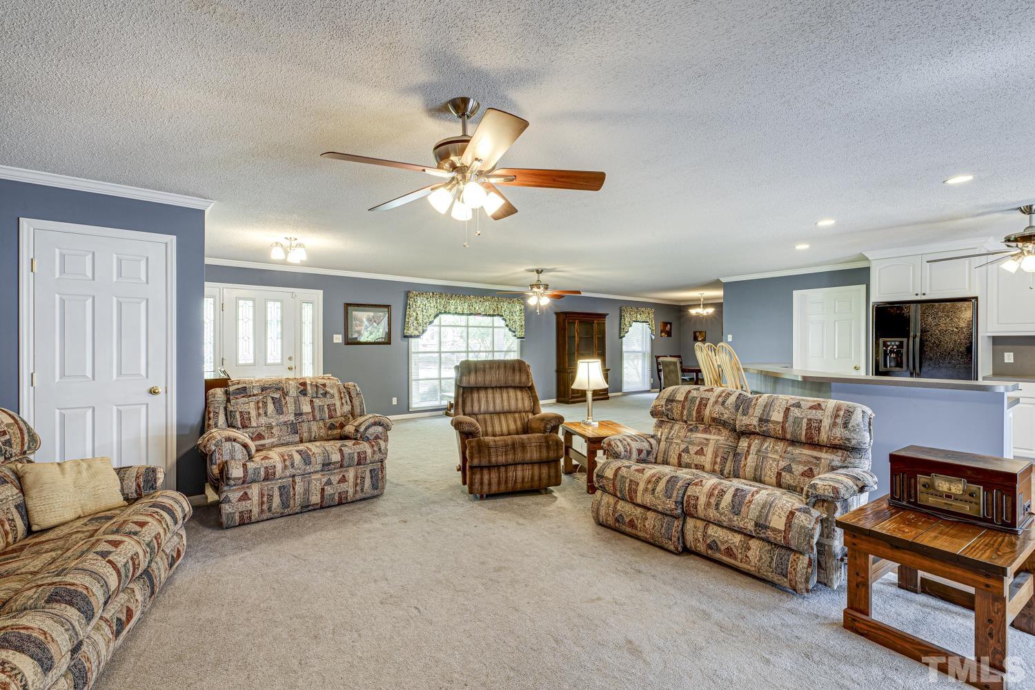 2822 Ellis Road Durham, NC 27703 - Photo 24 of 37 a living room with furniture and a flat screen tv