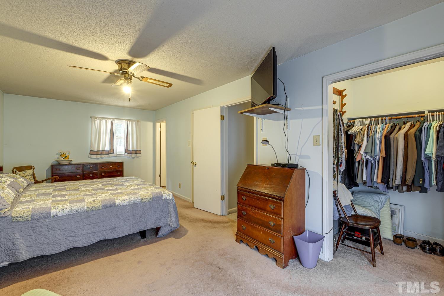 2822 Ellis Road Durham, NC 27703 - Photo 26 of 37 a bedroom with a bed and wooden floor