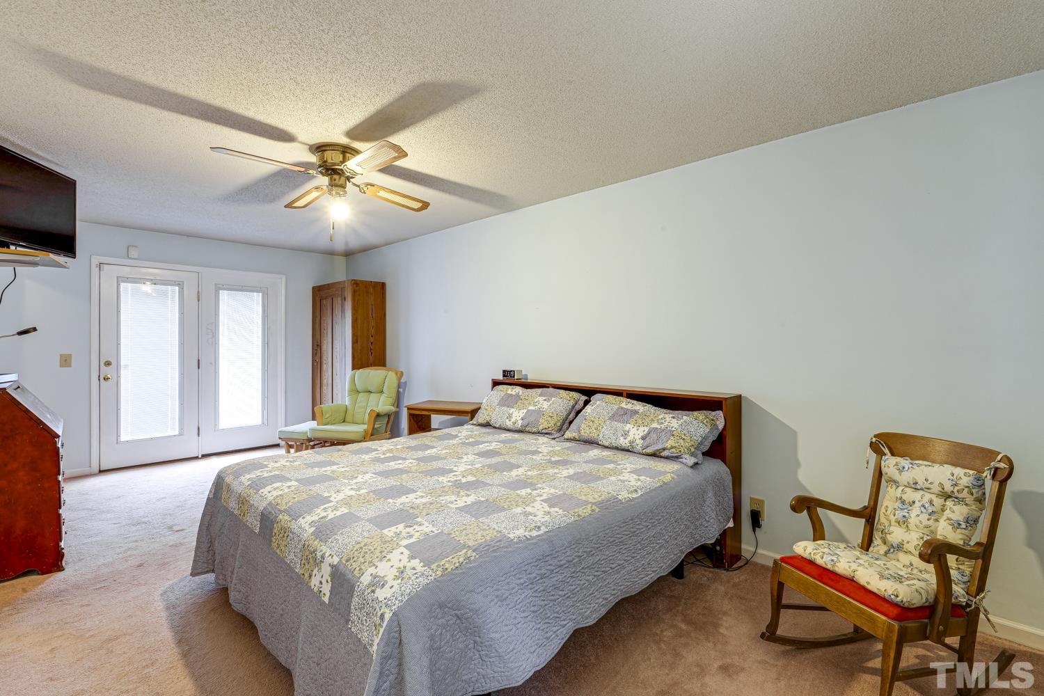 2822 Ellis Road Durham, NC 27703 - Photo 27 of 37 a bedroom with a bed and chair