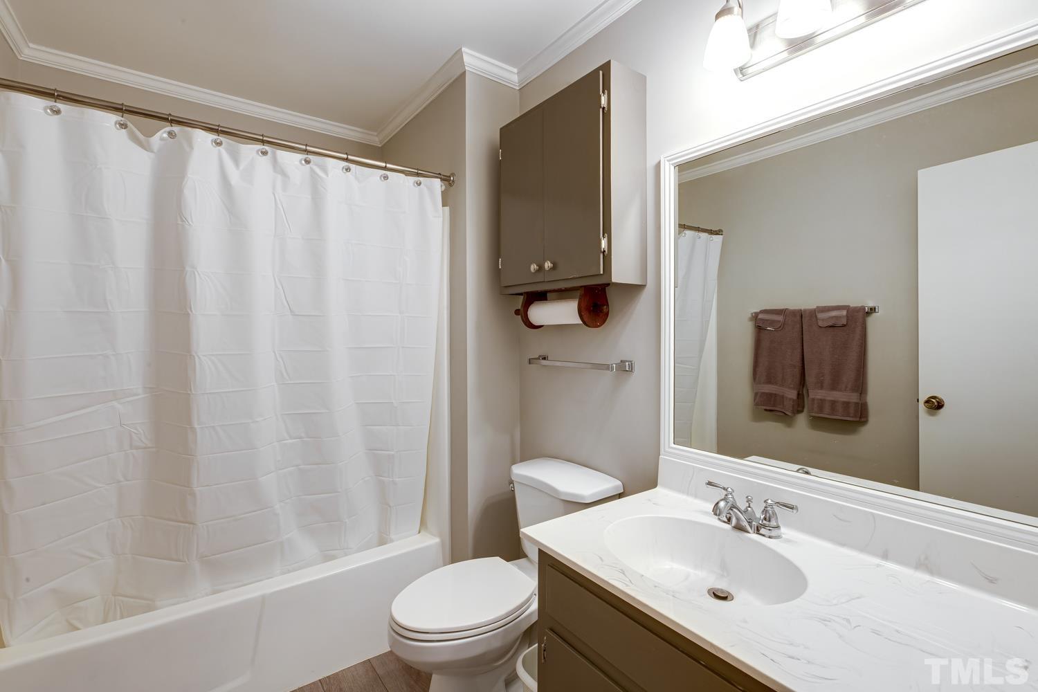 2822 Ellis Road Durham, NC 27703 - Photo 28 of 37 a bathroom with a sink toilet and shower
