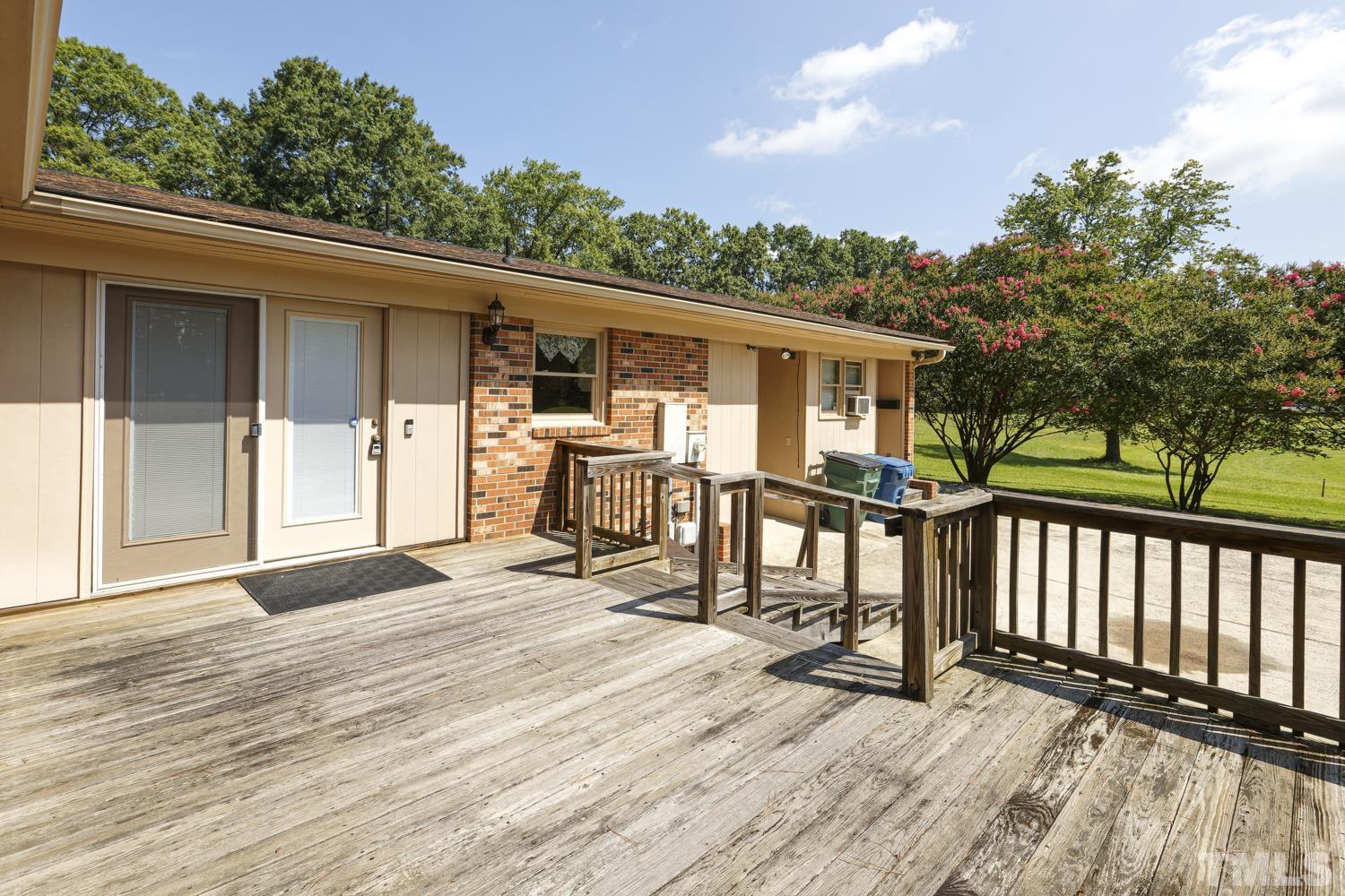 2822 Ellis Road Durham, NC 27703 - Photo 35 of 37 a view of a deck with table and chairs and wooden floor