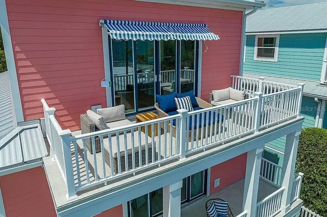 a kitchen with stainless steel appliances a dining table chairs and wooden floor