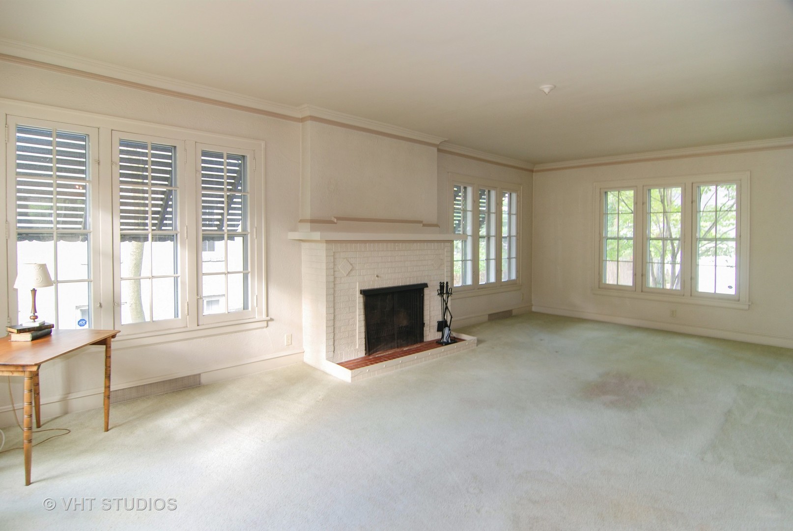 258 Lionel Road Riverside, IL 60546 - Photo 4 of 20 a view of an empty room with a fireplace and a window