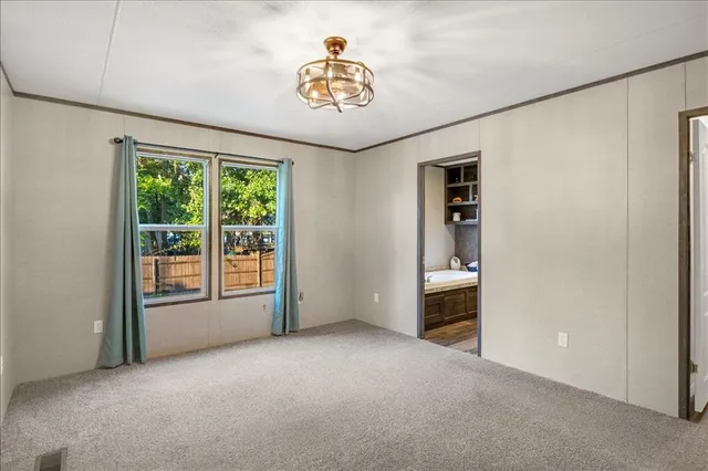 a view of empty room with floor to ceiling window