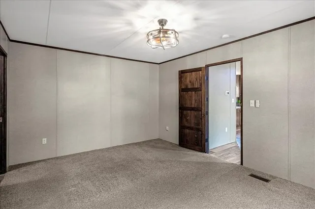 an empty room with windows and cabinet