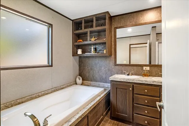 a bathroom with a granite countertop sink a toilet and a mirror