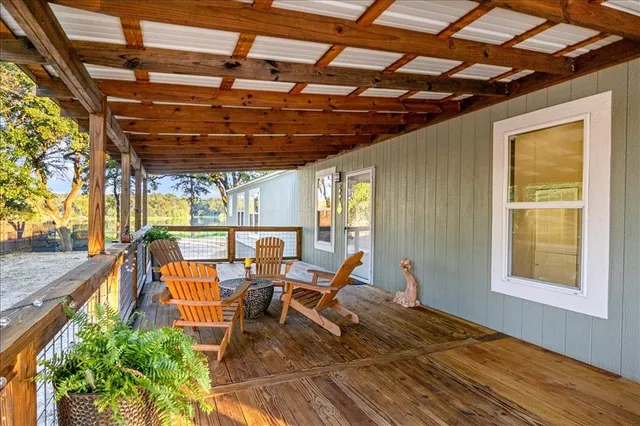 a outdoor space with the couches and dining table with the view of the swimming pool