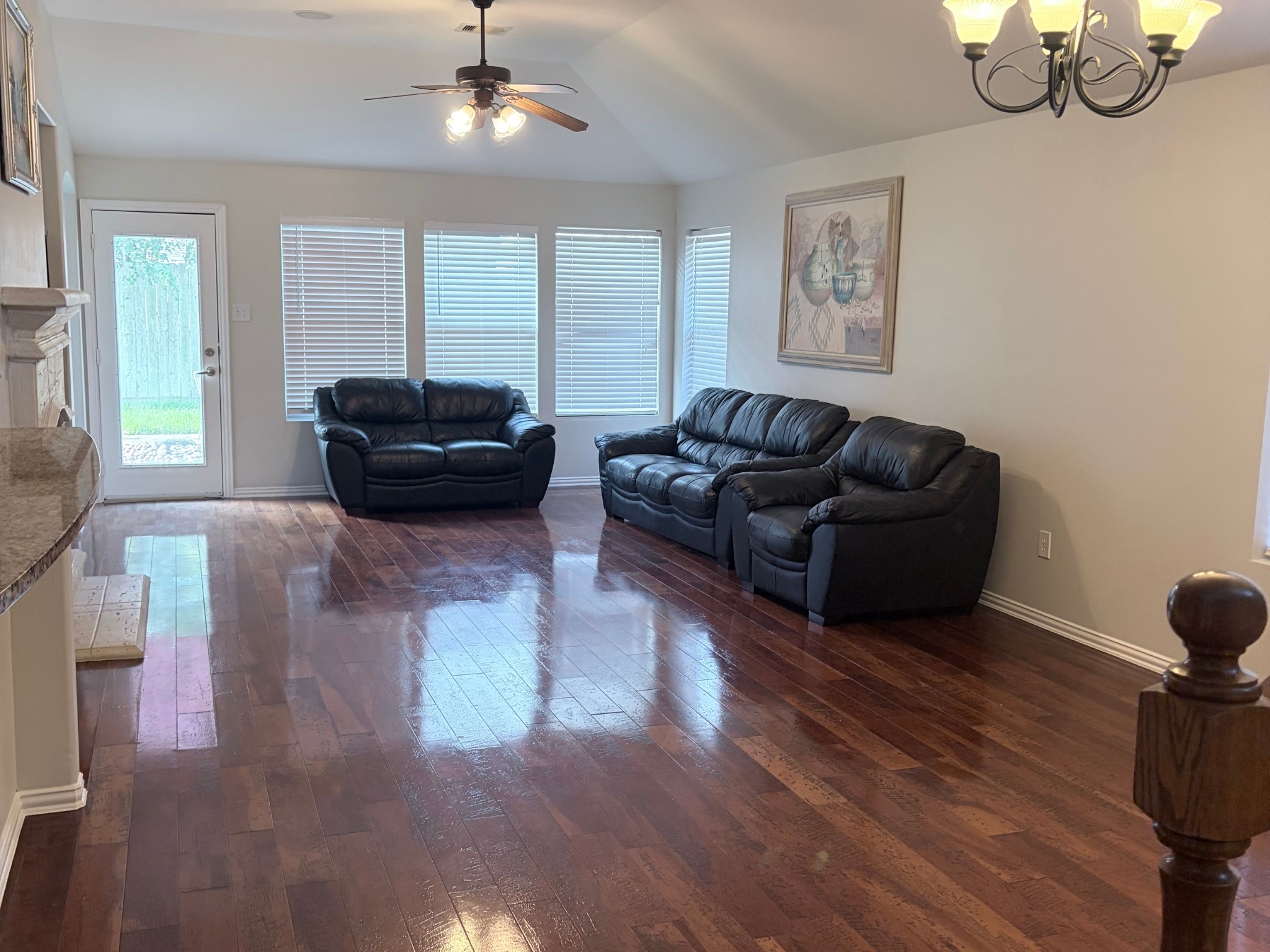 Spacious and bright formal living area featuring wood flooring and open-concept flow
