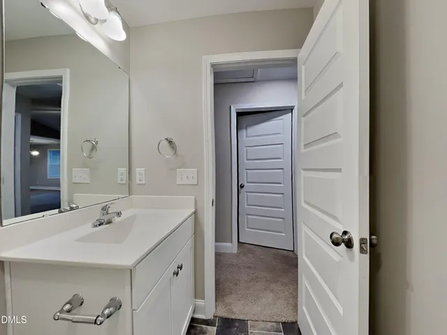a bathroom with a sink and mirror