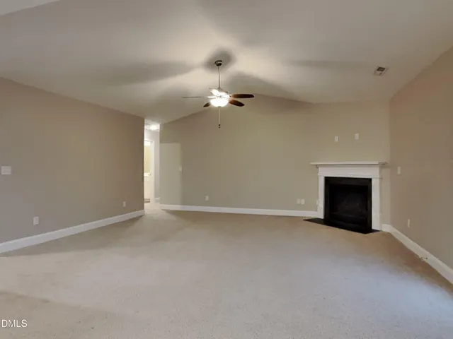 a view of an empty room with a ceiling fan