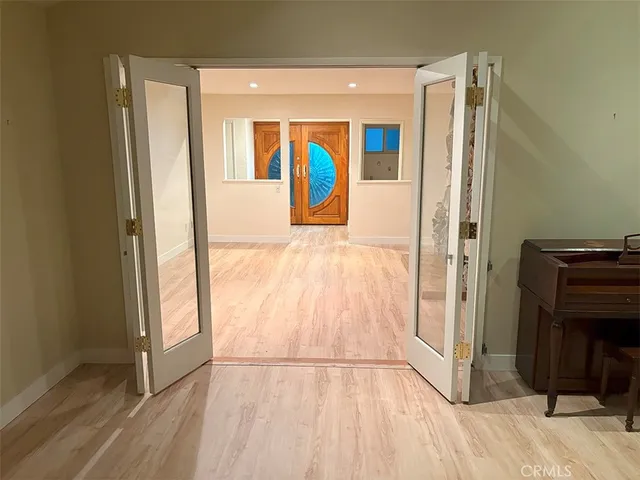 a view of a hallway with a wooden door