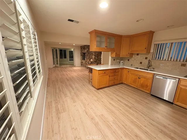 a kitchen with stainless steel appliances granite countertop a stove and a wooden floors