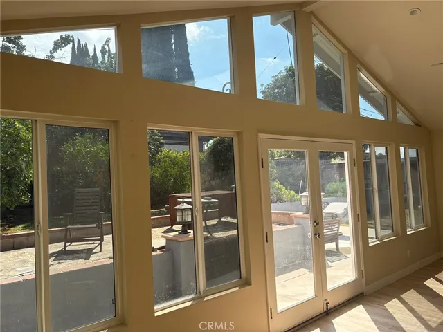 a view of a balcony with chairs and floor to ceiling window