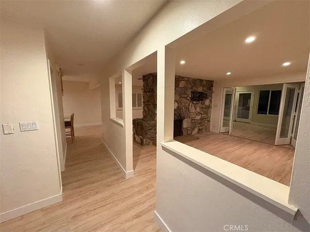 a view of a hallway with wooden floor and staircase