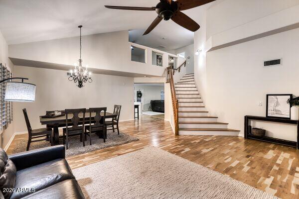 1609 East Mohawk Lane Phoenix, AZ 85024 - Photo 2 of 31 a dining room with wooden floor a chandelier a glass table and chairs